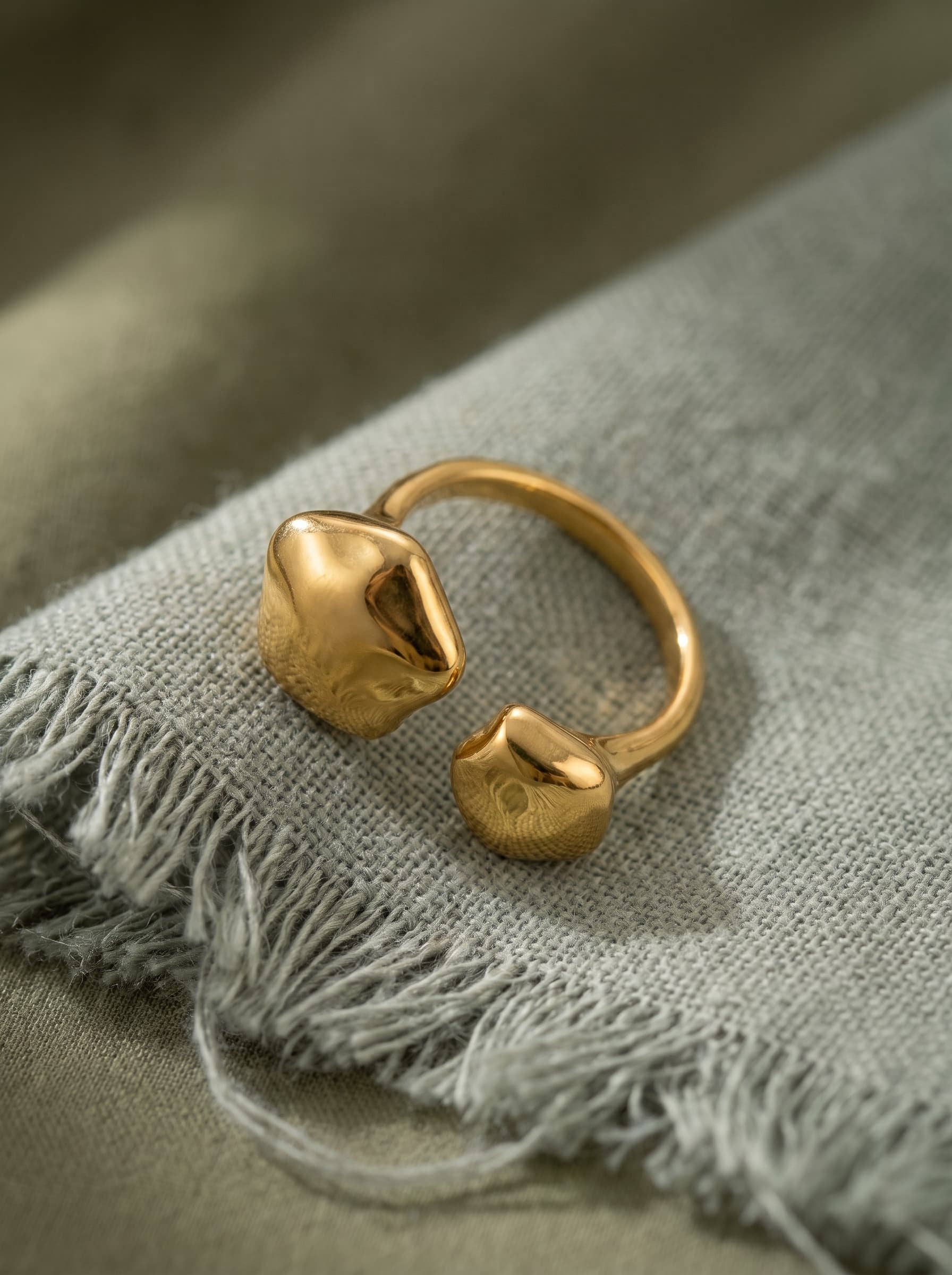 Molten Ring on sage-green linen